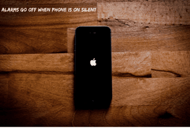 Black Iphone on Brown Table