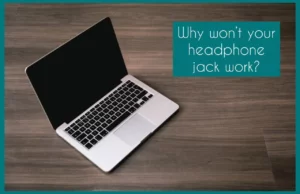 Macbook on brown surface with text "Why Won't Your Headphone Jack Work" Written
